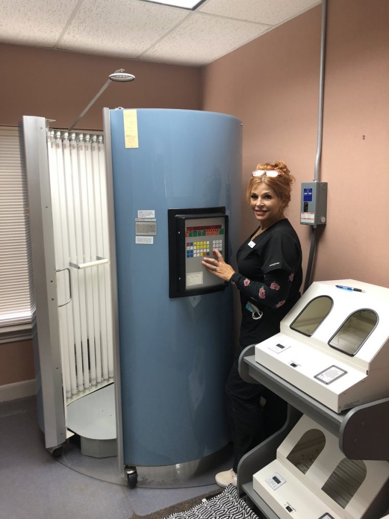 Photo of a medical assistant using the uvb phototherapy machine for treatment of Psoriasisat Dermatology and Laser Center of San Antonio
